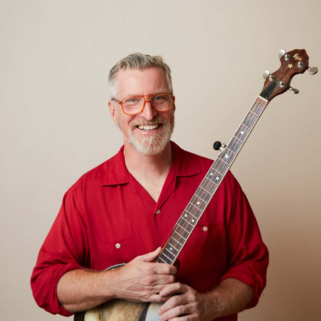 Chris Coole at Swallow Hill BanjoFest 2025 Artist Chris Coole, performing at Swallow Hill BanjoFest 2025, standing and smiling for a posed photo with his banjo