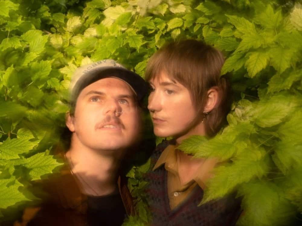 The 7 members of Rootbeer Richie and the Reveille, one of the bands performing at Indiewood, standing on a staircase outdoors with the sun shining on them